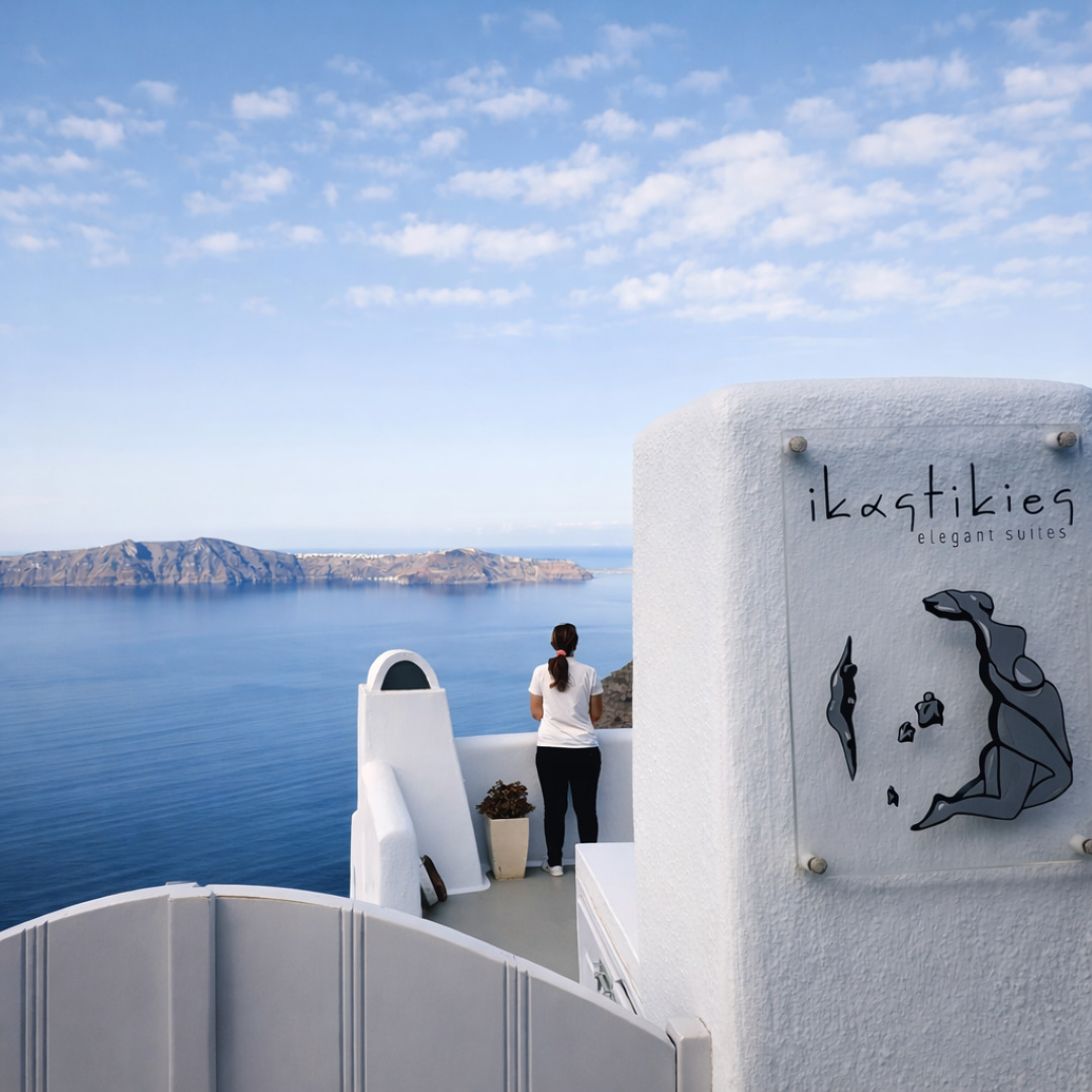 Guest admiring panoramic caldera view from boutique hotel in Santorini